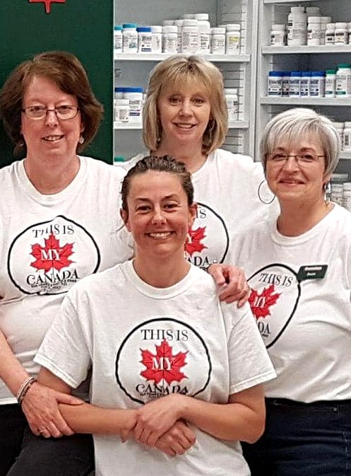 Ryan's Pharmacy team wearing Canada Day shirts in the pharmacy